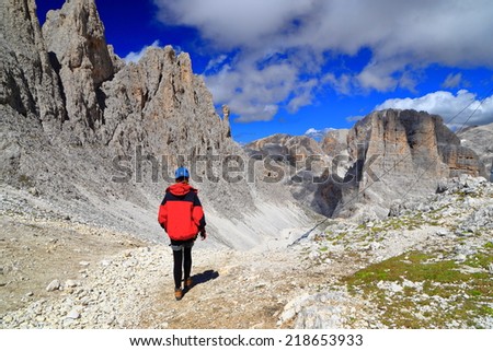 Woman climber descending towards Vajolet towers, Catinaccio massif, Dolomite Alps, Italy