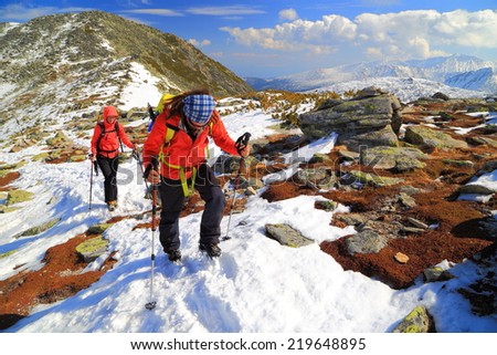 Team of climbers ascend a snow covered trail on the mountain