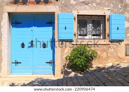 Vintage door and window with wood shutters wide open on sunny street of Mediterranean town, Rovinj, Croatia
