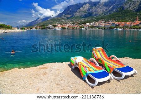 Beach chairs on sunny sea shore near the Dalmatian coast, Makarska, Croatia