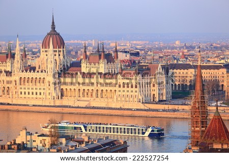 Danube river with tourist boat in front of the Parliament building, Budapest, Hungary