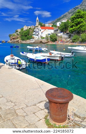 Iron anchor on a pier of small harbor on the Dalmatian coast, Croatia