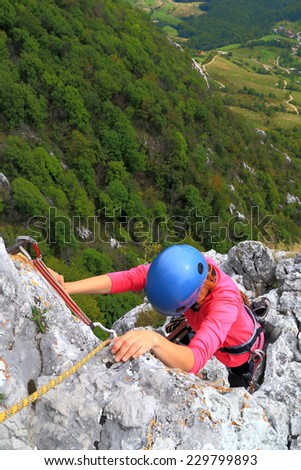Woman and climbing equipment on the limestone wall