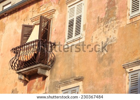 Aged facade of a traditional building on a street inside old town of Zadar, Croatia