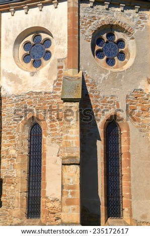 Gothic windows on aged wall of a medieval church, Transylvania, Romania