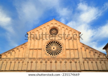 Blue sky and white clouds above highly decorated facade of a church in the old Venetian town of Zadar, Croatia