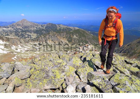 Young woman hiking on the mountain in beautiful spring day