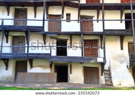 Old building with wooden doors and stairs inside fortified church in Prejmer, Transylvania, Romania