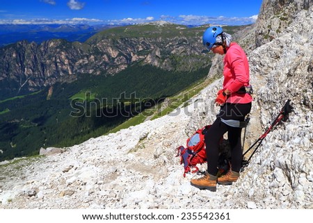 Woman puts on climbing gear on \