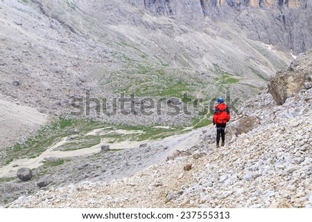 Snowy weather and woman climber on the Lasties Valley, Sella massif, Dolomite Alps, Italy
