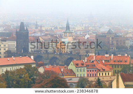 Thin layer of fog above Charles Bridge and church and Gothic towers in Prague Old Town, Czech Republic
