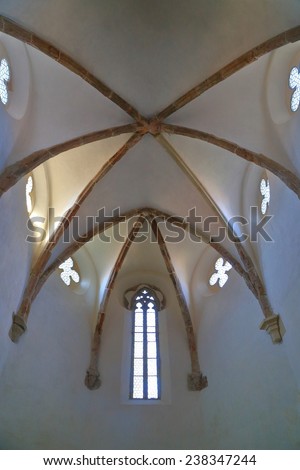 PREIMER, ROMANIA - OCT 11: Small windows and white ceiling of Fortified Church (listed on UNESCO World Heritage), Prejmer, Romania, October 11, 2014