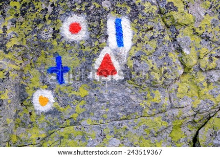 Trail indicators painted in granite boulder