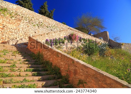 Sunny stairs climb to the top walls of Palamidi Castle near Nafplio, Greece