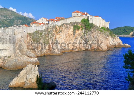 Fortified walls of Dubrovnik old town above blue Adriatic sea, Croatia
