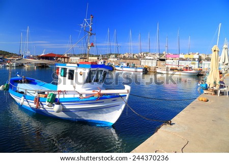 Greek fishing boat made of wood anchored inside Lavrion harbor, Greece