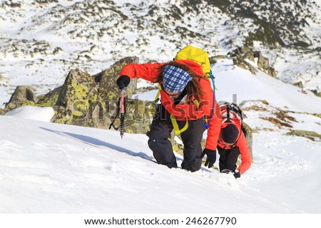 Sunny weather on the mountains and team of climbers during ascent in winter