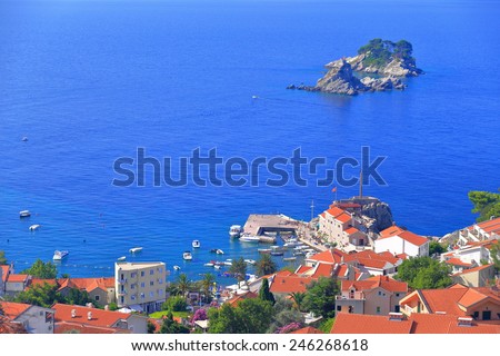 Adriatic sea harbor with old buildings and distant church isolate on top of small island