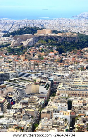 Narrow streets of the Greek capital with Acropolis hill and blue sea in the background, Athens, Greece