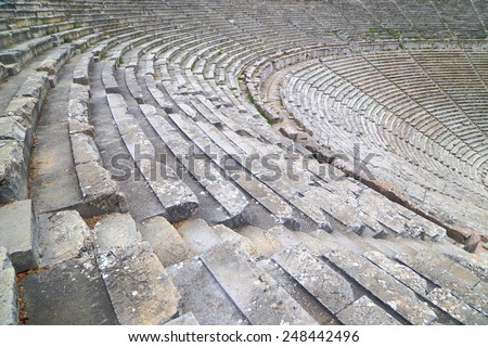 Wide rows of stone tribunes in ancient amphitheater, Epidaurus, Greece