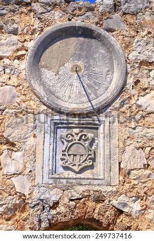 Stone wall with aged dial of a solar clock from the Dalmatian coast, Croatia