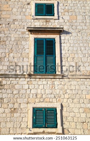 Pair of windows of a building with Venetian architecture inside the old town of Dubrovnik, Croatia