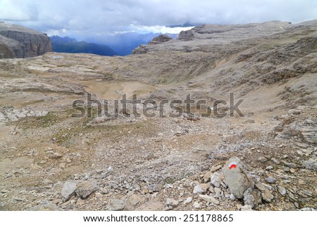 Trail mark painted on a rock on vast Meisules plateau, Sella massif, Dolomite Alps, Italy