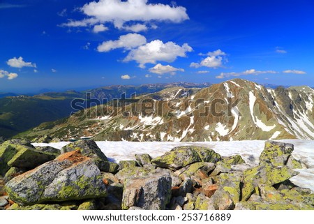 Mountain landscape with white stripes of remaining snow on the summits