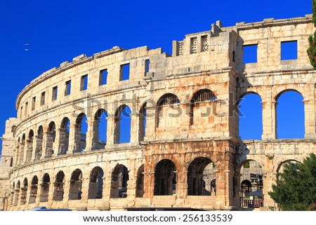Hollow arches of Roman amphitheater in sunny afternoon, Pula, Croatia