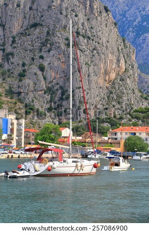 Dalmatian coast with small bay and harbor surrounded by steep mountains, Omis, Croatia