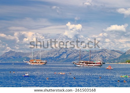 Tourist boats along Dalmatian coast in sunny day, Makarska, Croatia