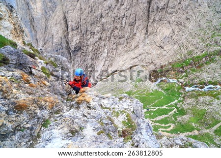 Daring woman climbs vertical walls on via ferrata \