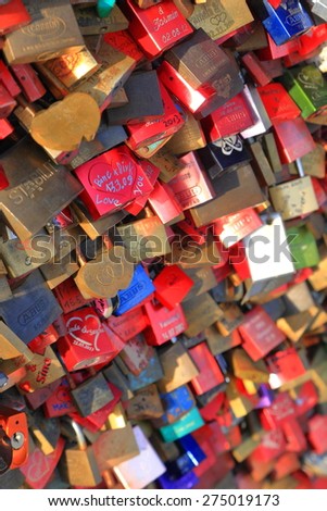 Cologne, Germany - APR 10 2015: Colorful steel locks placed by lovers cover entire side protection of the Hohenzollern Bridge