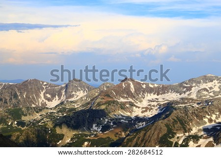Rocky summits spotted with snow in springtime