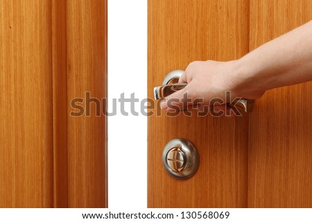 Hand opening the door. Horizontal format