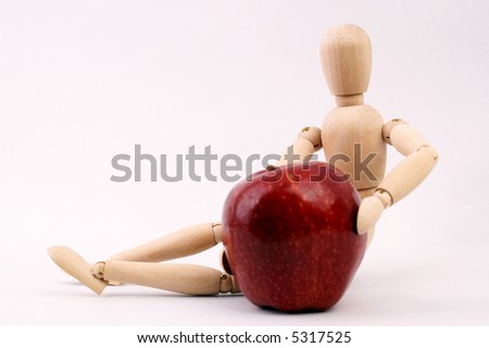 Red appel and wooden model, focus on model.