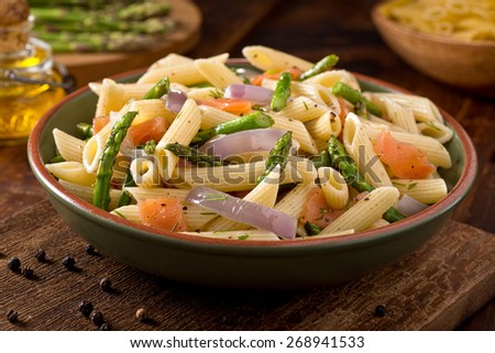 A delicious smoked salmon pasta with penne, asparagus, crushed black pepper, olive oil, and dill.