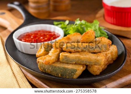 Delicious deep fried zucchini sticks with marinara dipping sauce.