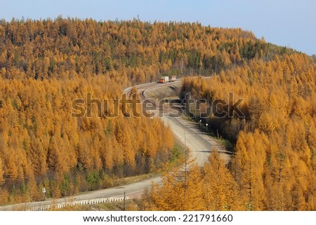 mountain road in South Yakutia with the car in autumn