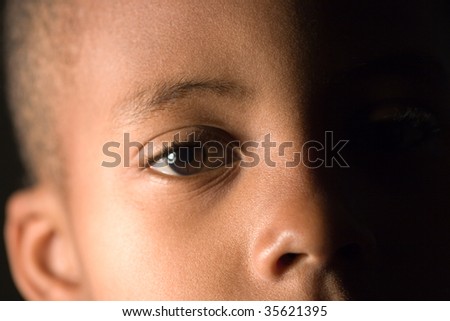 closeup of a boy\'s face in shadows