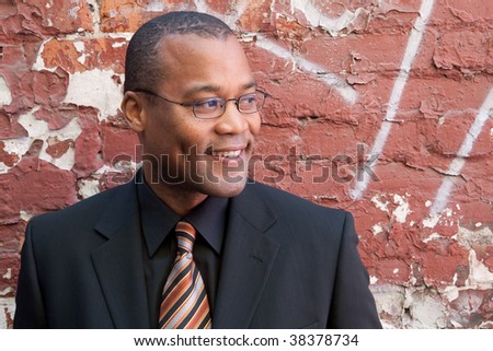smiling man in an urban environment visualizes a positive future