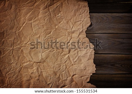 a piece of old paper on a wooden texture