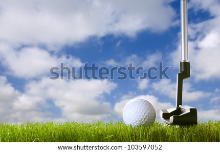 golf ball on green grass with club under sky