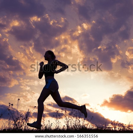 Silhouette Woman Run Under Blue Sky With Clouds And Sun