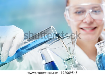woman scientist in laboratory with glass tubes