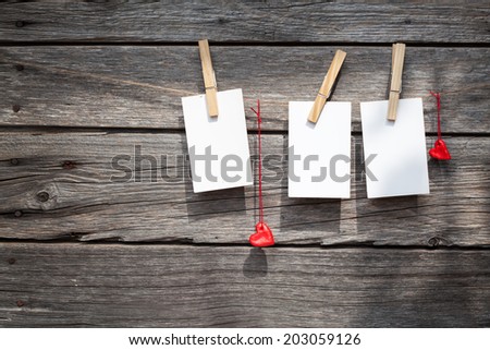 white paper on pins at wood background