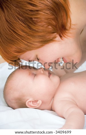 happy beauty mother and baby touch each other noses