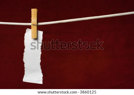scrap paper attach clothes-peg to rope on venous background