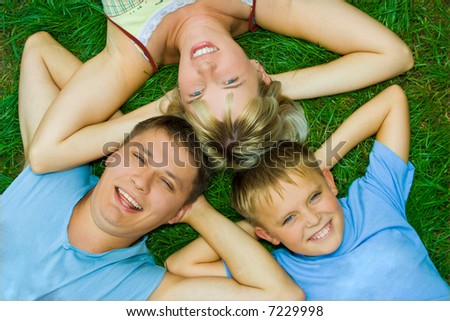 happy family three people on green grass