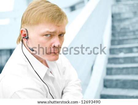 security guard in head phone on stairs